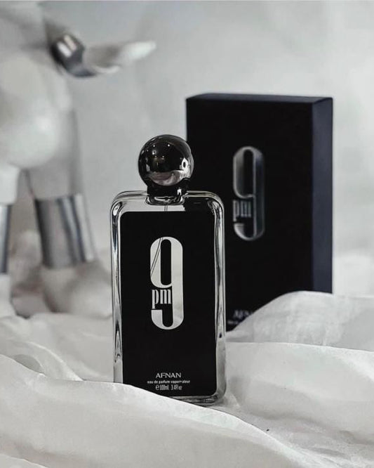 Black perfume bottle with '0' design on a white surface