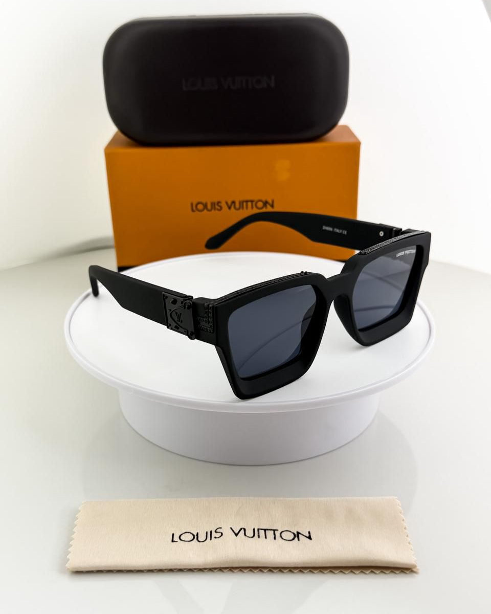 Black sunglasses with Louis Vuitton case and cleaning cloth on a white surface