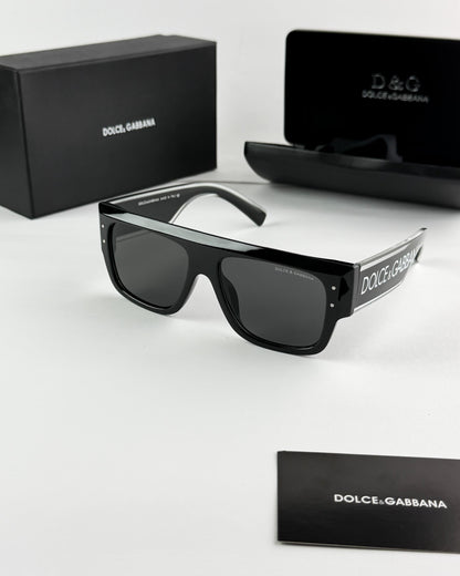 Black Dolce & Gabbana sunglasses with packaging on a white background