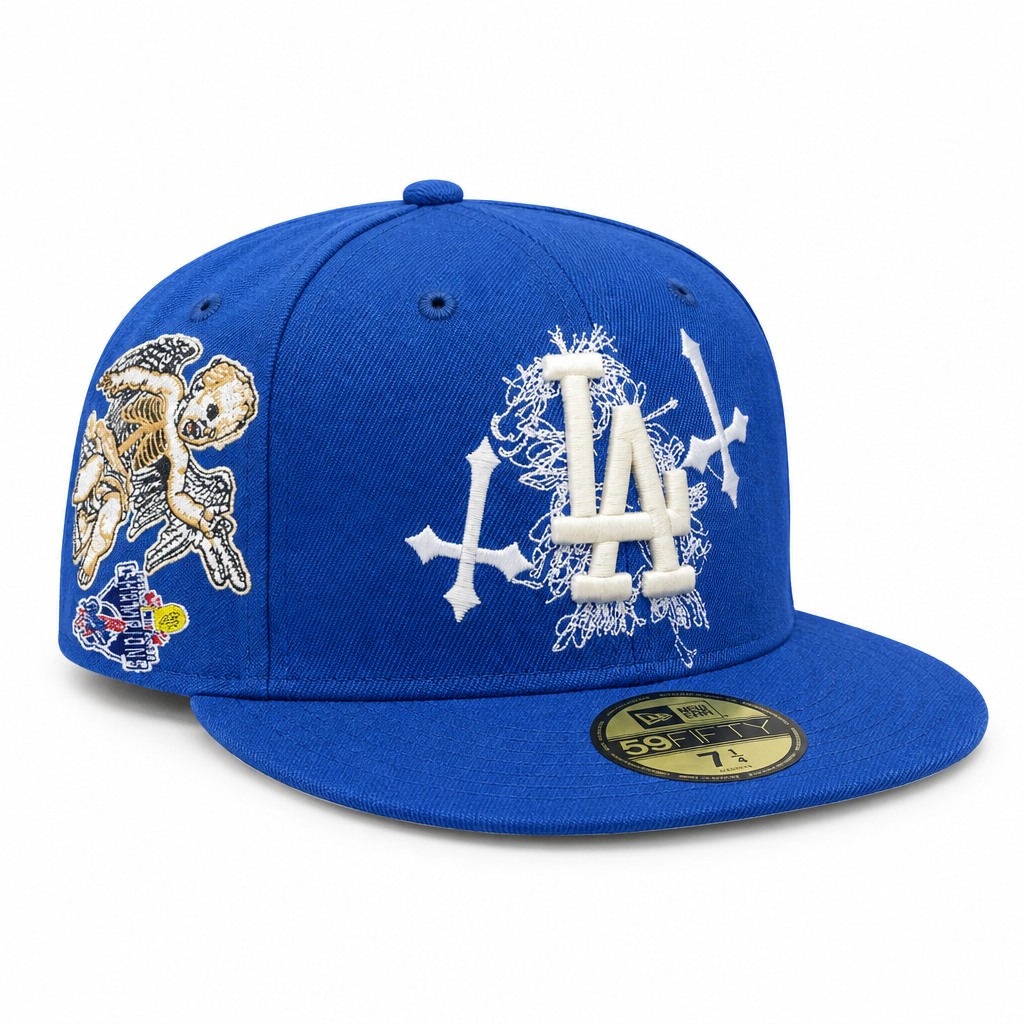 Blue fitted cap with embroidered front logo and side patch on white background