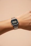 Vintage digital watch on wrist with silver stainless steel bracelet